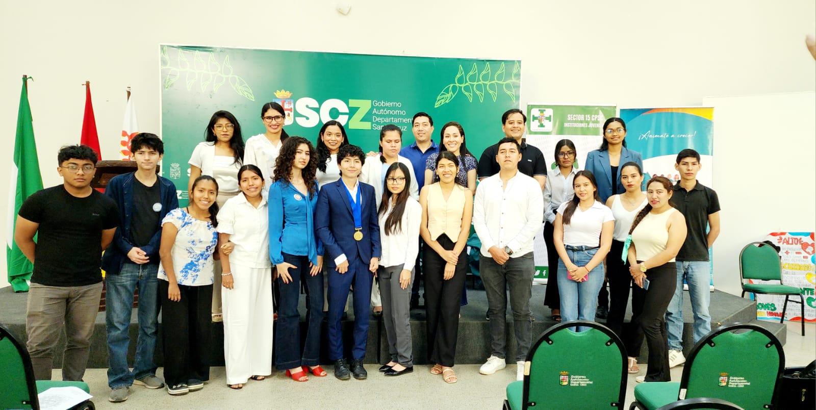 A diverse group of young people smiling and collaborating.